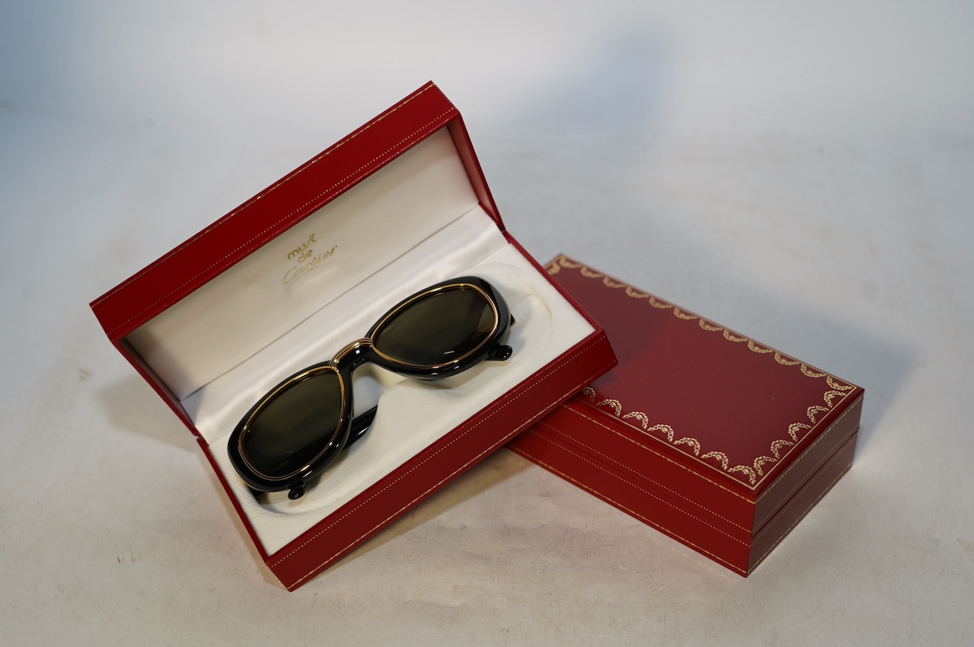 Two pairs of Must de Cartier sunglasses